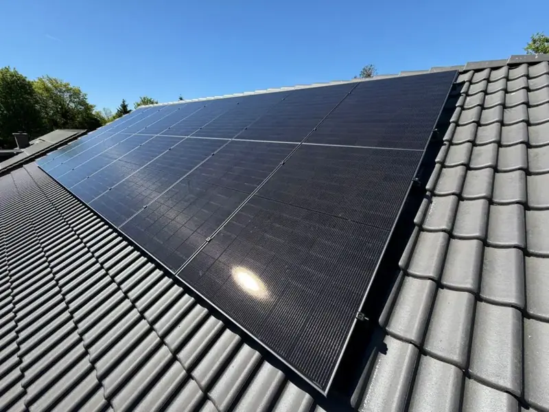 Zonnepanelen op een dak met grijze dakpannen